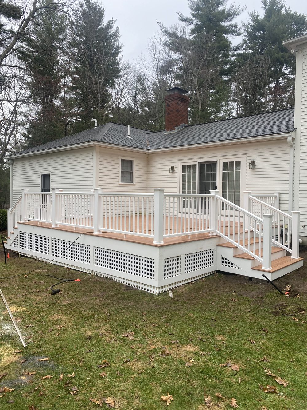 New composite deck build with white railing — Crafted Edge Construction Greater Boston MA