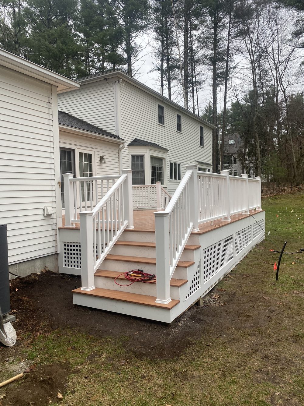 New deck with stairs and white railing — Crafted Edge Construction MA