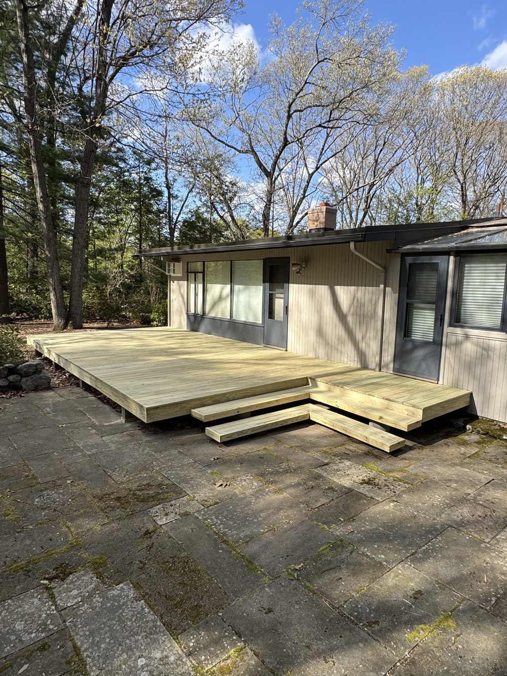 New pressure treated deck build with L-shaped steps — Crafted Edge Construction Greater Boston MA